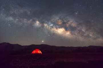 Wall Mural - red tent in reservoir under milky way galaxy with stars and space dust in the universe, long speed e