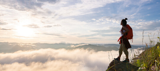 Wall Mural - hiker standing and watching the sea of ​​mist