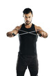 © Khushboo Sumeet/peopleimages.com - Fitness, training and resistance band with an athlete man isolated on a transparent background for strength. Exercise, health and wellness with a young male person on PNG for a strong arms workout