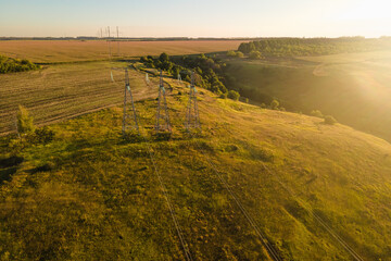 Wall Mural - Aerial shot of electrification infrastructure transmission towers in rural landscape