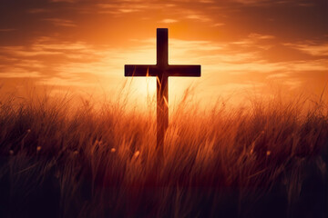 Silhouette christian cross on grass in sunrise background