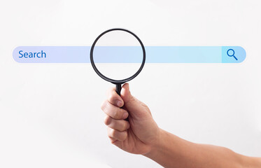 Wall Mural - businessman hand using magnifying glass to search on virtual screen on white background data search 