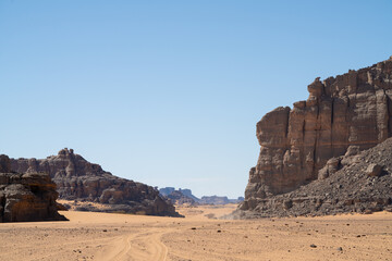 Sticker - view in the Sahara desert of Tadrart rouge tassili najer in Djanet City  ,Algeria.colorful orange sand, rocky mountains