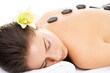 Hot stones, luxury spa and woman relax on massage bed on isolated, png and transparent background. Heat treatment, salon aesthetic and female person resting for pamper day, therapy and wellness