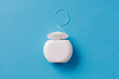 Dental floss for cleaning teeth on blue