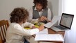 © andrea - Father and son 9-year-old elementary school boy doing homework - doing school-given math exercises for the summer holidays - childhood lifestyle student with computer laptop