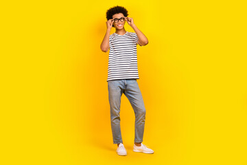 Wall Mural - Full body photo of young man wear striped t-shirt eyeglasses successful entrepreneur fits accessories isolated on yellow color background