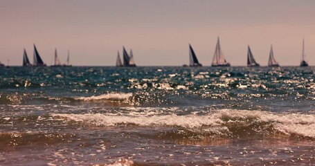 Wall Mural - Sunny beach sunrise and sailing boat and yacht vessels in regatta racing in the sea. Yachting competition 4K video