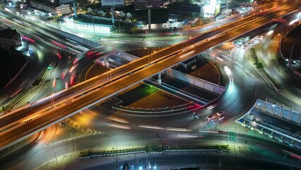 Wall Mural - Expressway top view, Road traffic an important infrastructure,car traffic transportation above intersection road in city night, aerial view cityscape of advanced innovation, financial technology	