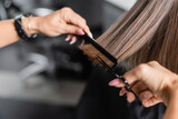 close up of scissors and comb, salon hair tools, cropped view of professional hairdresser cutting short brunette hair of woman, beauty worker, haircut, beauty salon work, hairdo
