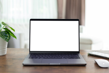 mock up empty screen computer on wood desk in home.Notebook Laptop with blank screen