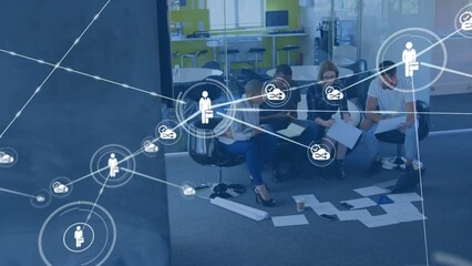 Wall Mural - Animation of network of digital icons against diverse colleagues with documents working at office