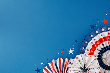 Wall Mural - Fourth of July celebration concept. Top view flat lay of paper party props,stars confetti on blue background with space for promo or text