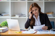 © Wuttichaik - Tired exhausted  fatigue angry business woman manager bookkeeping law firm accounting bored sleepy sitting at desk, business woman stressed about meeting online project document on laptop computer