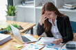 © Wuttichaik - Tired exhausted  fatigue angry business woman manager bookkeeping law firm accounting bored sleepy sitting at desk, business woman stressed about meeting online project document on laptop computer