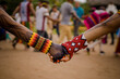 Sao Paulo, SP, Brazil - April 20 2023: People holding hands wearing traditional colorful bracelets of indigenous peoples details.