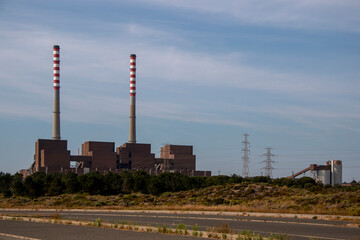 Factory producing electricity with two huge chimneys