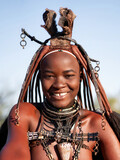 Happy Himba woman smiling, dressed in traditional style in Namibia, Africa.