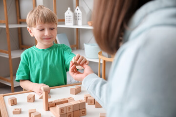 Sticker - Little boy and nanny playing with cubes at home