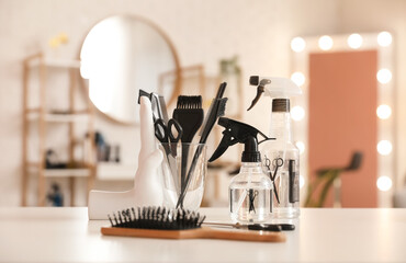 Wall Mural - Different hairdressing tools on table in beauty salon