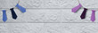 © Yuliia - Banner panorama with garlands of ties. Business style. Multi-colored ties cut out of paper on background of white brick wall. Copy space. Header for website, blog, article, flyer.