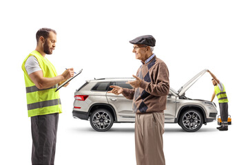 Wall Mural - Elderly man talking about a car problem with a road assistance worker