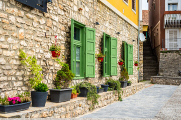 Wall Mural - Beautiful green jalousie windows of renovated old building with stone walls