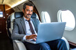 Latino businessman in private jet, laptop, boss, entrepreneur, ceo, luxury jet, remote work, diversity, millionaire, success