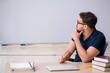 © Elnur - Young male teacher sitting in the classroom