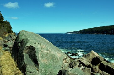 Wall Mural - big stone on the shore by the ocean