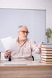 © Elnur - Old male teacher sitting in the classroom