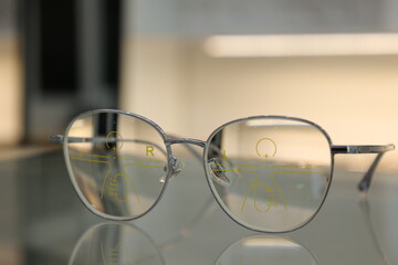 Wall Mural - Eyeglasses on table, progressive lenses, eyeglasses for the elderly, glasses progressive lens, eyeglass progressive lens, close-up of glasses on lenses test, looking through glasses