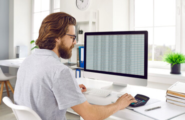 Financial manager calculating about cost and doing finance. Accountant checking financial documents using computer and calculator in office. Audit, tax, accounting and analytical research concept