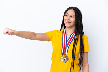 Poster - Teenager girl with braids and medals over isolated pink background giving a thumbs up gesture