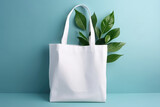 Fototapeta  - Mockup for design of white canvas shopper bag with green plant leaves isolated on pastel blue background with copy space. Eco-friendly plastic free bag template. Generative AI 3d render.