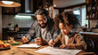 © Robert Kneschke - Black father helping daughter with homework at kitchen table