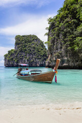 Wall Mural - Traditional longtail boat with beautiful scenery view at Maya Bay on Phi Phi Leh Island in sunshine day.