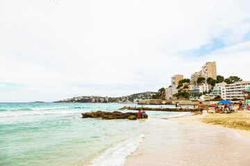 Wall Mural - City beach on Palma de Mallorca. Sea, people, hotels and residential buildings.