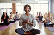 © Dangubic - Optimistic Small Business Male Owner Leading Serene Meditation in Modern Yoga Studio. Generative AI.
