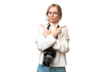 Sticker - Young photographer English woman over isolated background pointing to the laterals having doubts