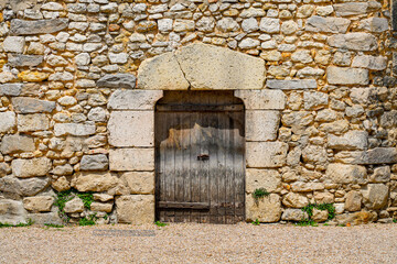 Wall Mural - Wooden door on the wall of the medieval castle of Nemours in the town of the same name in the Loing valley south of Fontainebleau in the French department of Seine et Marne in Paris region