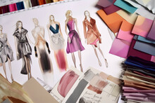 Generative AI Illustration From Above Of Various Fashion Dresses Sketches Near Fabric Swatches And Palette In Workshop