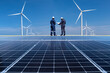 © APchanel - Engineers walking on roof inspect ,check and Maintenace solar cell panel by hold blue print and t blet by windmill turbine and solar cell are ecology energy sunlight alternative power factory concept.