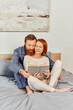© LIGHTFIELD STUDIOS - quality time, reading book together, happiness, day off without kids, redhead husband and wife, happiness, bearded man and woman, relaxation, parents alone at home, lifestyle, adult leisure