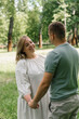 © Guys Who Shoot - portrait of a couple in love a man and a pregnant woman are hugging, waiting for a new addition to the happy family