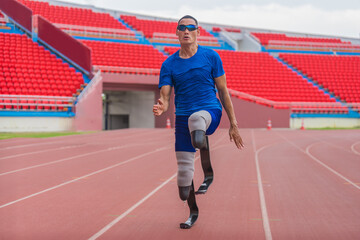 Wall Mural - Asian male athlete with prosthetics runs at full speed, demonstrating a powerful practice on stadium track