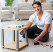 © Elnur - Man assembling furniture at home