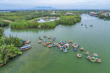 Wall Mural - Aerial view, tourists from Thailand, Korea, America and Japan are relax and experiencing a basket boat tour at the coconut water ( mangrove palm ) forest in Cam Thanh village, Hoi An,Quang Nam,Vietnam