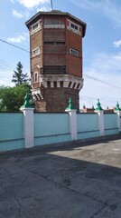 High water tower near the green fence