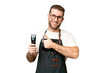 © luismolinero - Barber man in an apron over isolated chroma key background giving a thumbs up gesture